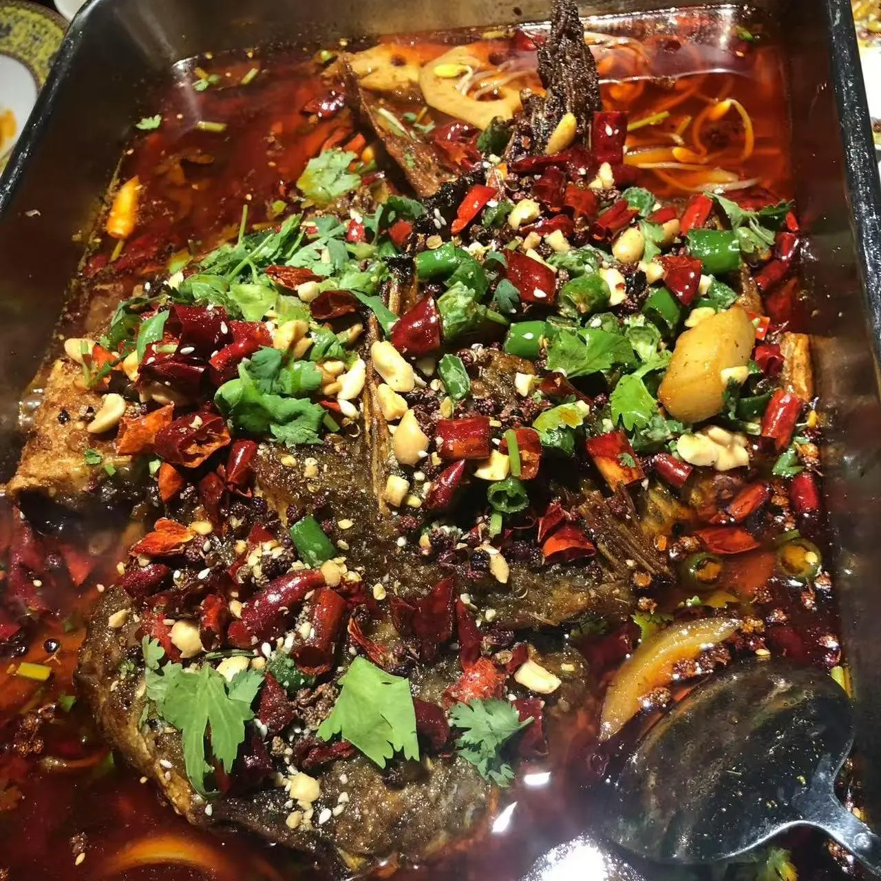 Whole fish cooked in spicy broth, topped with chilies at 成都名堂 SZECHUAN MASTER, a Chinese restaurant in Plano